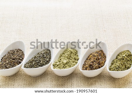 bowls of seaweed diet supplements (bladderwrack, sea lettuce, kelp, wakame and Irish moss) on burlap canvas with a copy space