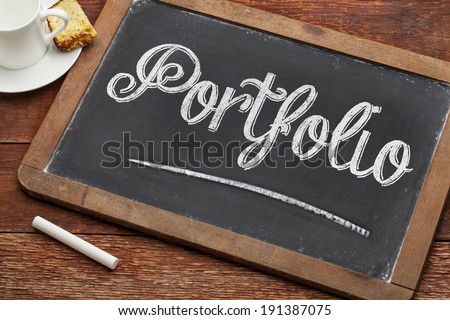 portfolio word with white chalk on a vintage blackboard with a cup of coffee