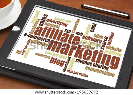 affiliate marketing word cloud on a digital tablet with a cup of tea