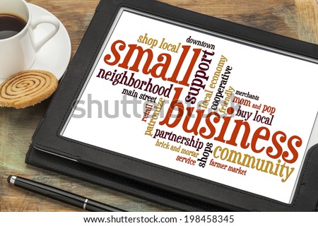 small business word cloud on a digital tablet with a cup of coffee