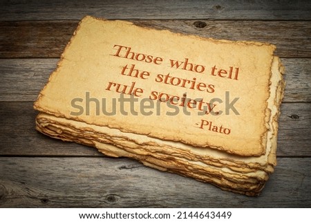 Those who tell the stories rule society, Plato, ancient Greek philosopher, quote. Inspirational handwriting on handmade paper against rustic weathered wood, storytelling and narration concept. Stockfoto © 