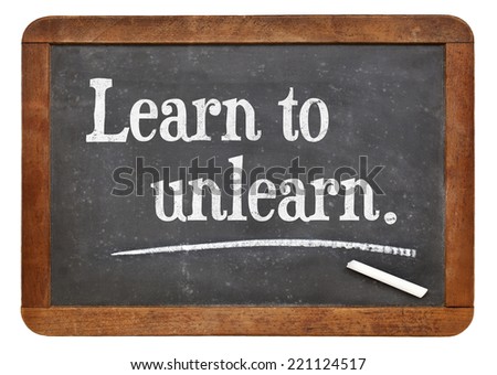 learn to unlearn - advice or motivation words on a vintage slate blackboard