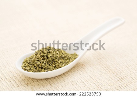 sea lettuce flakes on a white Chinese spoon against burlap canvas