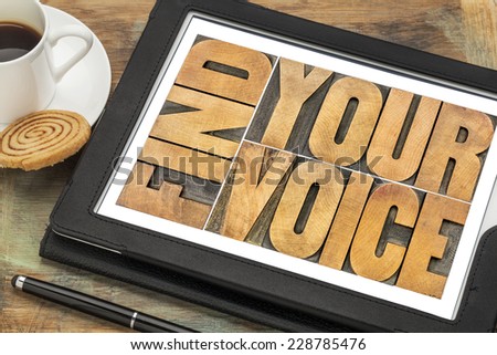 find your voice creativity concept - word abstract in letterpress wood type on a digital tablet with a cup of coffee