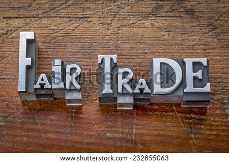 fair trade words in vintage metal type printing blocks over grunge wood - ethical business concept