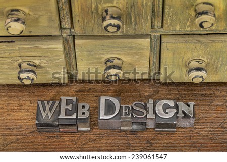 web design - text in vintage letterpress metal type blocks on a grunge wood with rustic drawer cabinet in background