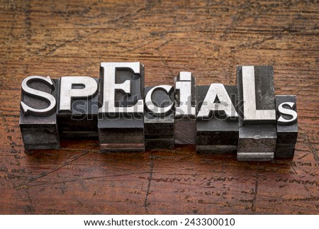 specials word in mixed vintage metal type printing blocks over grunge wood