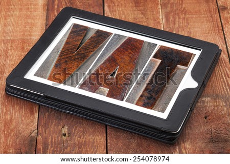 VAT (value added tax) - text in letterpress wood type printing blocks on a digital tablet