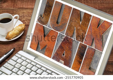 junk mail - text in letterpress wood type blocks on a laptop screen