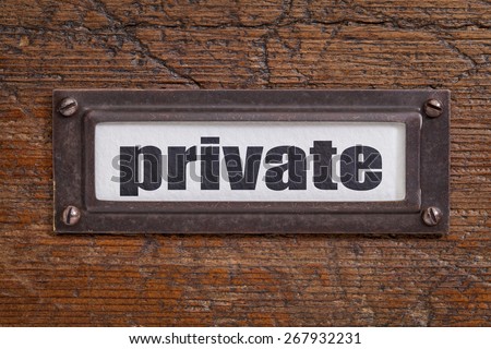 private  - file cabinet label, bronze holder against grunge and scratched wood
