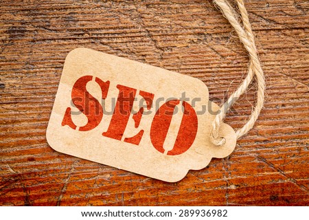 SEO - search engine optimization acronym on a paper price against rustic wood