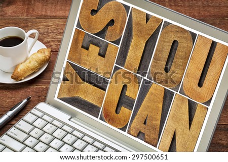 Yes you can - motivational slogan - a  text in vintage letterpress wood type printing block on a laptop screen with a cup of coffee