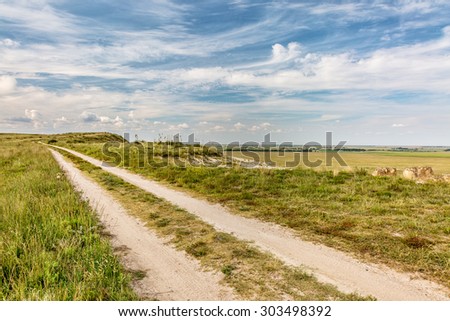ranch road over prairie in eastern Kansas near Castle Rock, summer scenery,