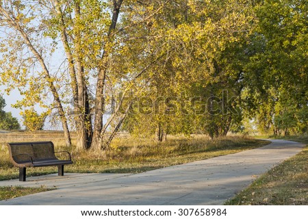 bench and recreational biking trail in Boyd Lake State Park near Loveland, Colorado, fall scenery