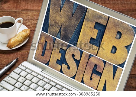 web design word abstract - text in vintage letterpress wood type block on a laptop screen with a cup of coffee