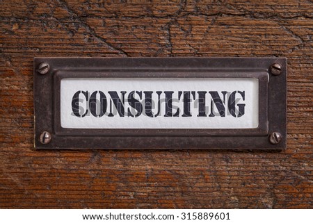 consulting - file cabinet label, bronze holder against grunge and scratched wood