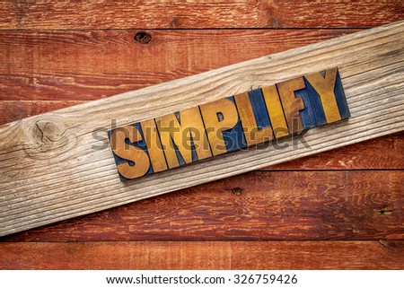 simplify word rustic sign - letterpress wood type over grained cedar plank against red barn wood