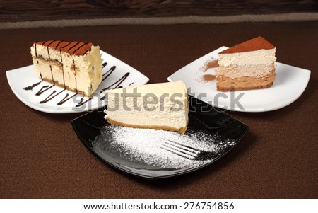 Tiramisu and chocolate cheesecake on a dark background. Dessert.