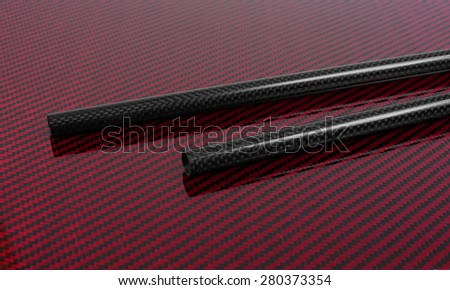 Carbon-Kevlar composite sheet. Carbon fiber tube. Texture.