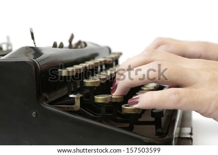 close up of woman typing with old typewriter