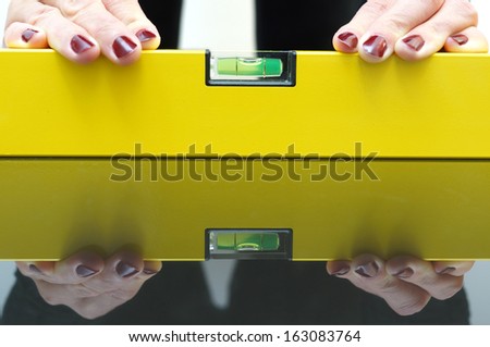 A woman using a spirit level for home work