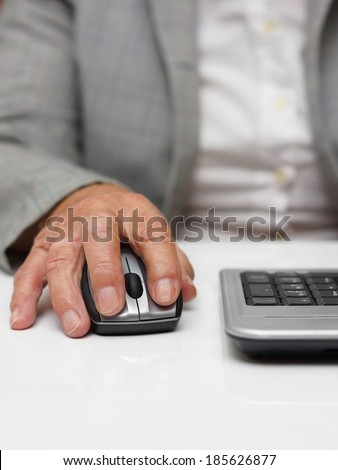 very old woman typing on computer mouse
