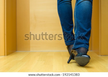 Female legs in jeans and  high heel shoes waiting