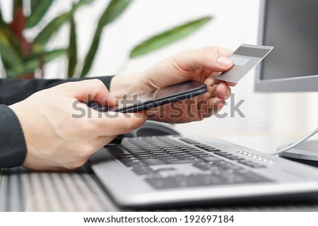Man is using credit card and mobile phone for  on line payment. mobile  shopping concept