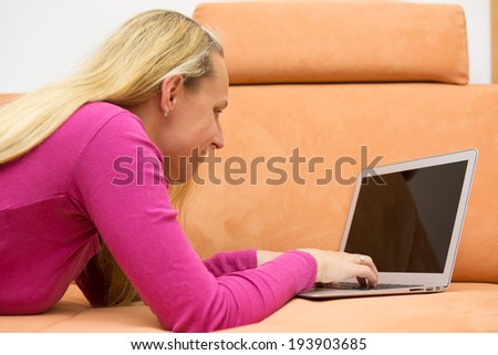 woman lying on the couch and chat over the internet