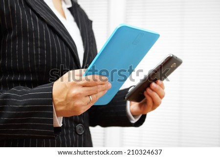 busy businesswoman using digital tablet and mobile phone at the same time
