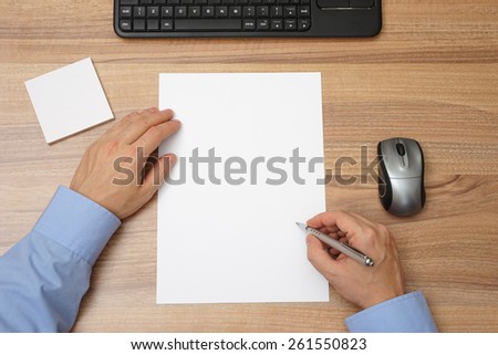 Businessman  with blank paper and pen in hand  to begin with writing. top view