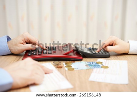 husband and wife are calculating monthly expenses. tight budget concept