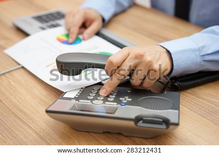 businessman calling client to inform him of the company\'s operations