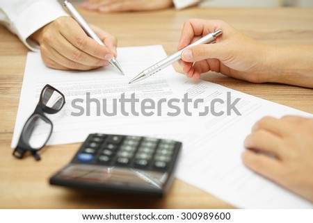 Businesswoman is explaining terms and conditions in agreement to his client before he sign the document