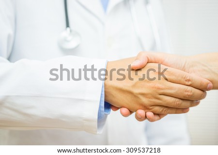 Doctor is handshaking with patient