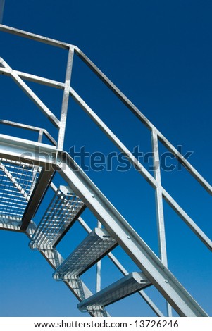 New silver steel stairs with blue sky
