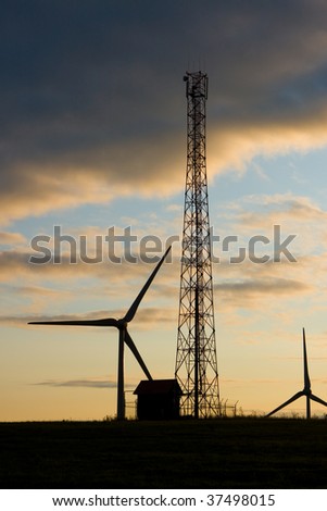 Photo of Wind power silhouette installation in sunny day
