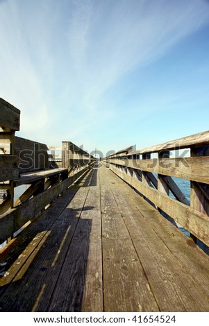 Long pier with vanishing point at horizon