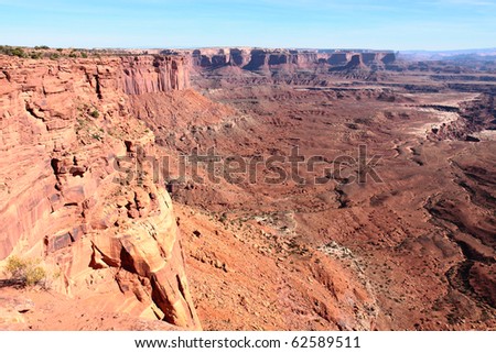 Sheer cliffs of red sandstone drop into deep ravines in Canyonlands National Park in Moab, Utah
