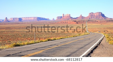 Main highway leading to tall monoliths, buttes, mesas and rock formations in the northern Arizona desert inside the Navajo Indian Reservation around Monument Valley