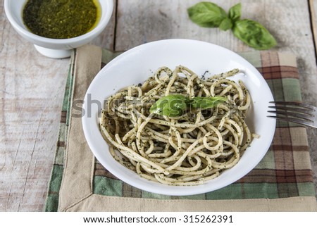 Spaghetti with homemade pesto sauce after cooking in a pan.