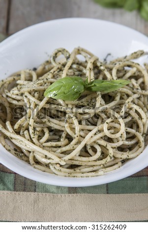 Spaghetti with homemade pesto sauce after cooking in a pan. Close up