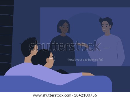 A young couple cuddling and watching a movie on a video projector, a lockdown leisure