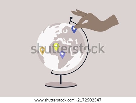 A round Globe on a metal stand with location pin stickers on it, educational and travel concept