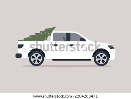 A side view of a big pick up truck delivering a Christmas tree, a cargo transportation concept, seasonal holidays
