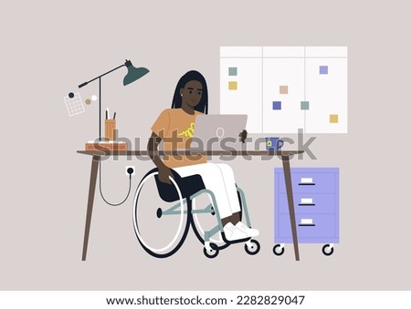 A young African person using a wheelchair works at a desk in the office