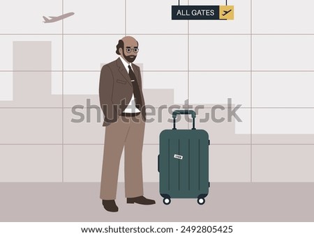 A man in a brown suit stands at the airport, waiting to depart, He has a suitcase with a luggage tag next to him