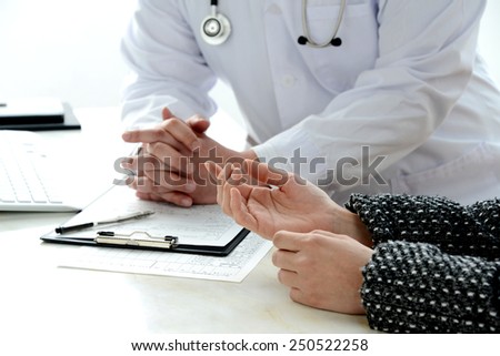 Patient's hand explaining for doctor