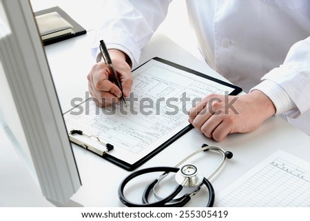 Doctor writing medical record and explaining for patient