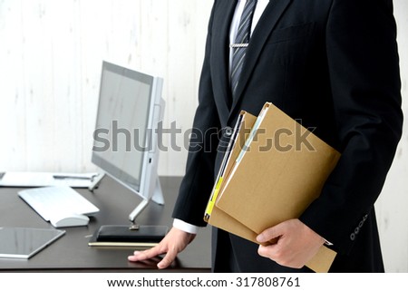 Businessman having files in office